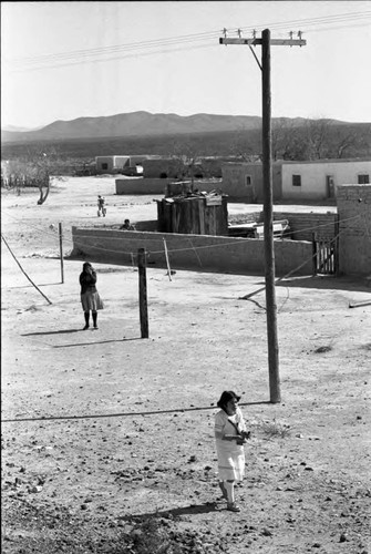 Woman and a group of children near train tracks, Chihuahua, 1983