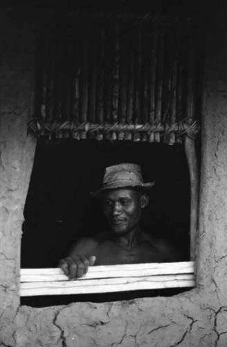 Man with a hat works on a window, San Basilio de Palenque, 1975