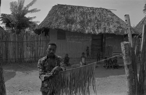 Man braiding palm leaves for a broom, San Basilio de Palenque, 1977