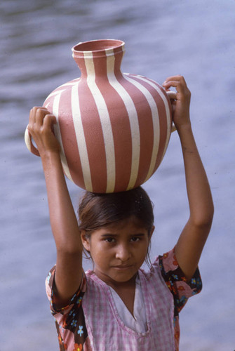 A Mayan girl carries a jug of water, Ixcán, ca. 1983