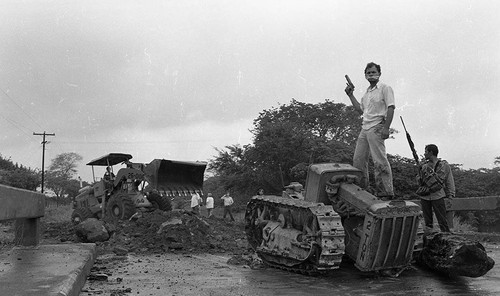 Sandinista standing on a destroyed tank, Nicaragua, 1979