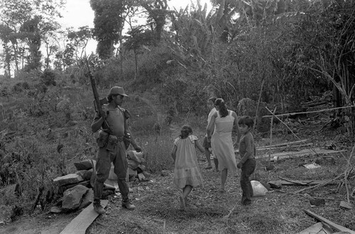 Civilians walking in front of militaty outpost, Perquín, 1983