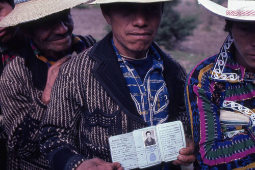 Mayan man showing his identification in line to vote, Sololá, 1982