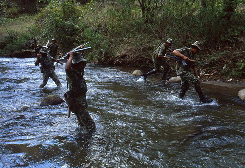 Armed soldiers crossing a river, Zaragoza, 1982