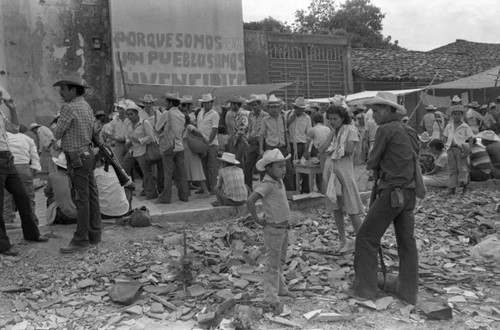 Residents and guerrillas gather at local market of controlled town, Corinto, 1983