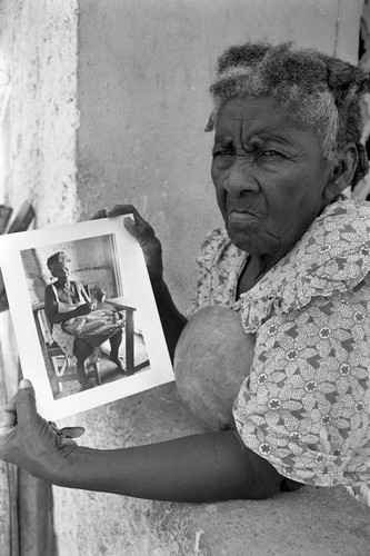 Woman holding a portrait, San Basilio de Palenque, 1977