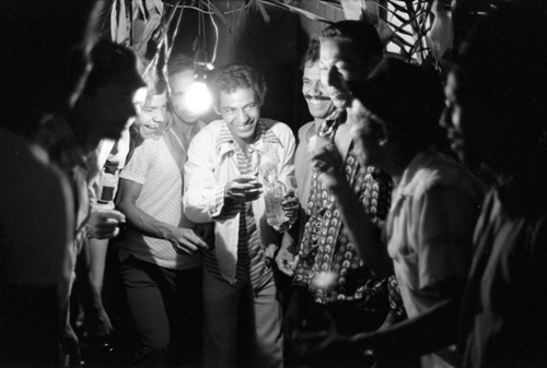 Men celebrating in the evening, Barranquilla, Colombia, 1977