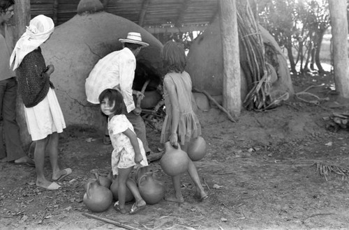 Man operating an oven, La Chamba, Colombia, 1975