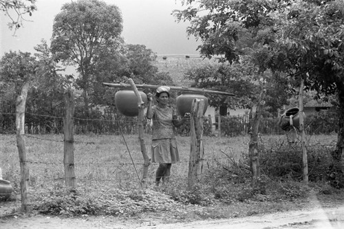 Transporting clay goods, La Chamba, Colombia, 1975