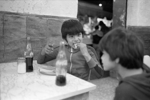 Two boys at a restrauant, Mexico City, 1982