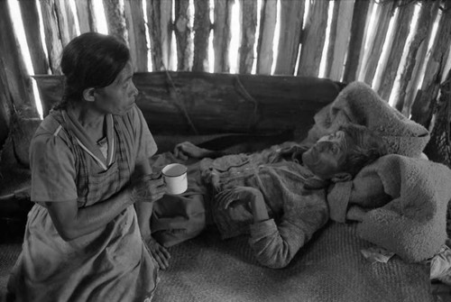 Refugee woman and man inside a hut, Chiapas, 1983