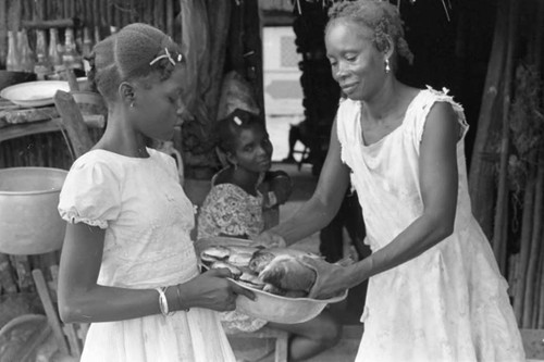 Woman and girl with fish in a metal bowl, San Basilio de Palenque, 1975