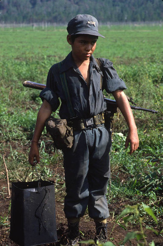 A child Contra soldier on a field, Nicaragua, 1983