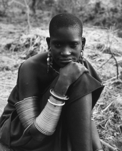 Young woman sitting outdoors, Tanzania, 1979