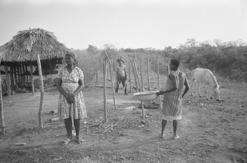 Villagers working near a palapa, San Basilio de Palenque, Colombia, 1977