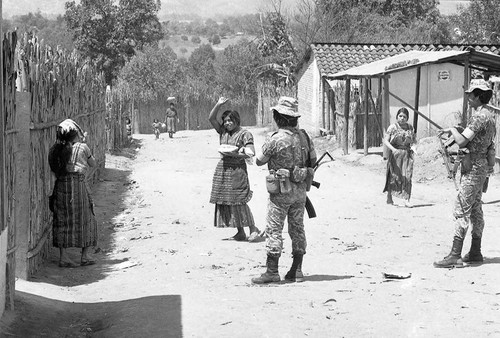 Soldiers patrolling a village, Guatemala, 1982