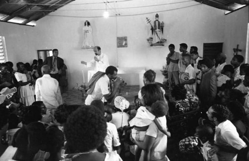 Priest preparing to celebrate a baptism, San Basilio de Palenque, 1975