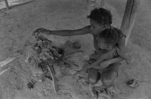 Young woman and infant by the fire, San Basilio de Palenque, 1977