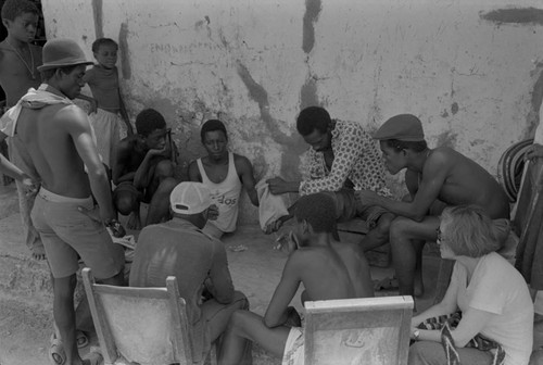 Nina S. de Friedemann watches men playing a game, San Basilio de Palenque, ca. 1978