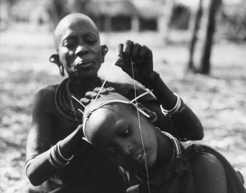 Woman attaching a headdress, Tanzania, 1979