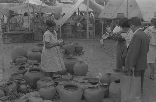 Woman selling clay goods at the market, La Chamba, Colombia, 1975