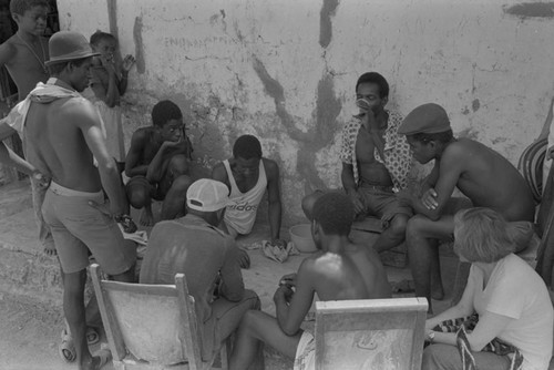 Nina S. de Friedemann watches men playing a game, San Basilio de Palenque, ca. 1978