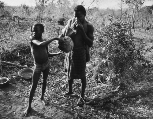 Man and boy with containers, Tanzania, 1979