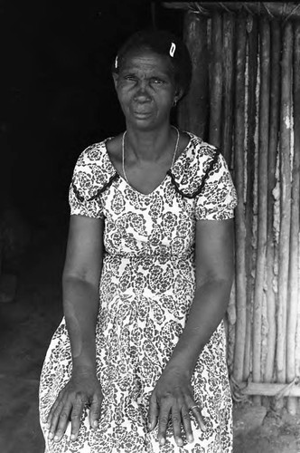 A woman sits by a doorway, San Basilio de Palenque, 1975