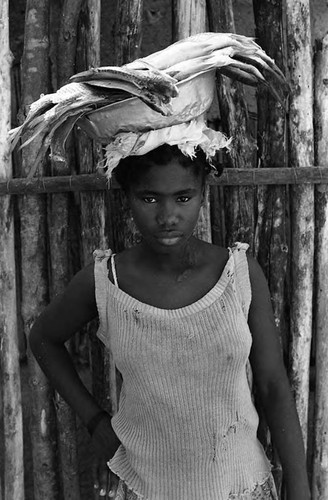 Young woman with plate of fish on her head, San Basilio de Palenque, 1975