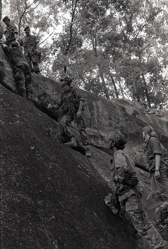 Survival school students learn to rock climb, Liberal, 1982