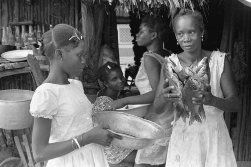 Woman and girl with fish and a metal bowl, San Basilio de Palenque, 1975