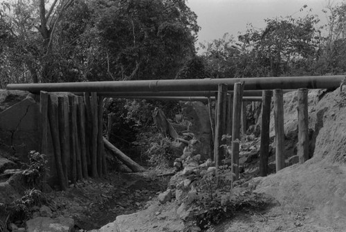 Water pipes passing over a ditch, San Basilio de Palenque, ca. 1978