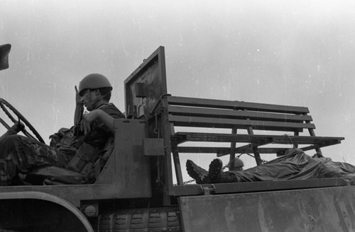 Soldier sits near a corpse, Nicaragua, 1979