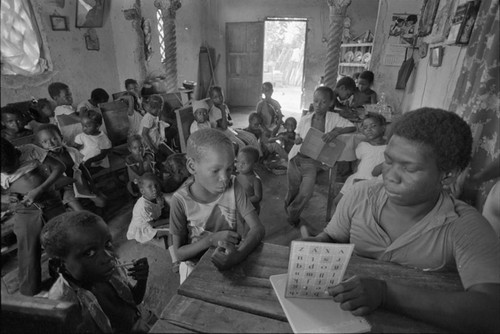 Teacher working with students in informal classroom, San Basilio de Palenque, ca. 1978