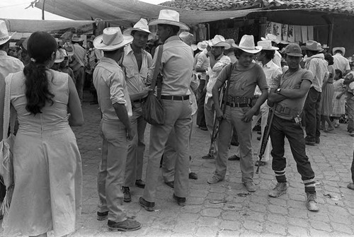 Guerrilleros looking intently, Corinto, Morazán, 1983