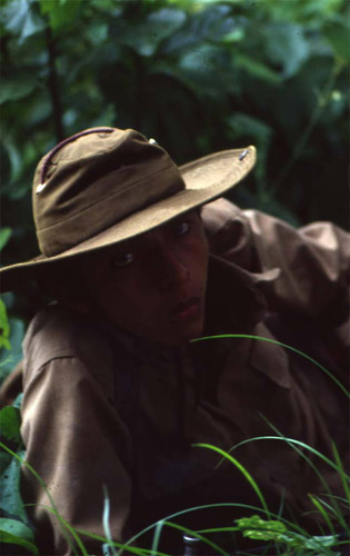 Sandinista taking cover in brush, Leon, 1979