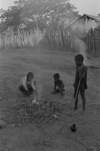 Children playing with a small fire in the street, San Basilio de Palenque, ca. 1978