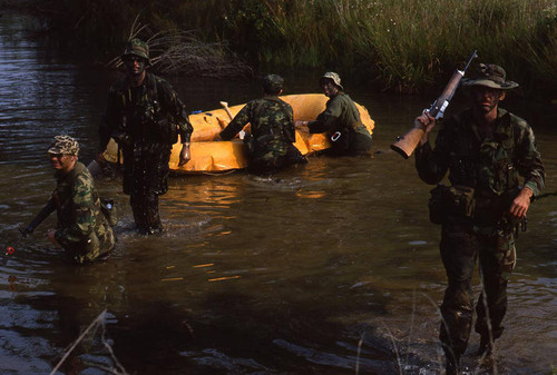 Survival school students stand near a raft, Liberal, 1982