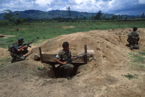 Three soldiers kneel with firearms, Honduras, 1983