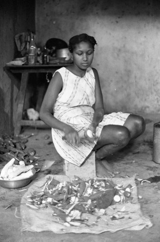 Woman peeling a tuber, San Basilio de Palenque, 1976