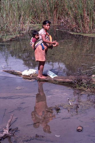 Guatemalan refugee washing her hair in the river, Cuauhtémoc, 1983