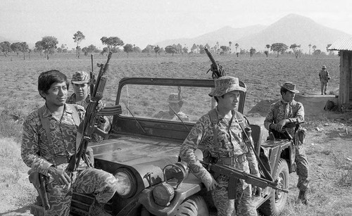 Soldiers resting on a vehicle at a checkpoint, Guatemala, 1982