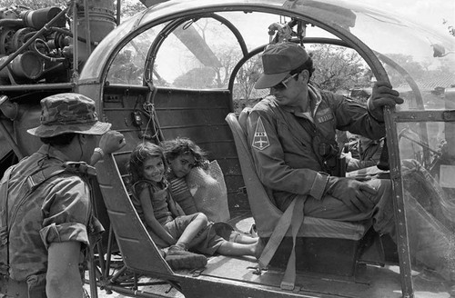 Two girls travelling n helicopters with soldiers, Department of Cabañas, 1982