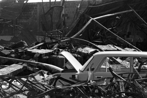 Destroyed building and car, Managua, 1980