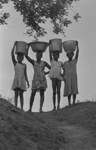 Four girls and their water containers, San Basilio de Palenque, Colombia, 1977