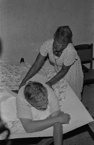 Woman giving a massage to a visitor, San Basilio de Palenque, ca. 1978