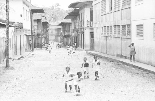 School children running through the street, Barbacoas, Colombia, 1979