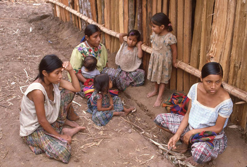 Mayan women and child refugees gather outdoors, Chajul, ca. 1983