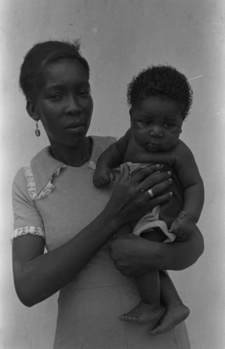 Woman holding a child in her arms, San Basilio de Palenque, 1975