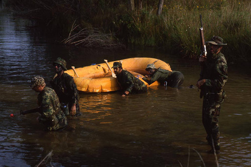 Survival school students stand near a raft, Liberal, 1982